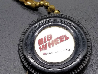 Meqasuring tape advertising "Big Wheel" tire center front view.